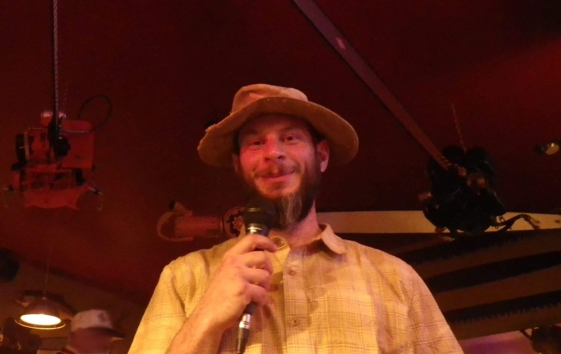 Jason Robo posing with a microphone for trivia night at The Logger Bar in Blue Lake, California